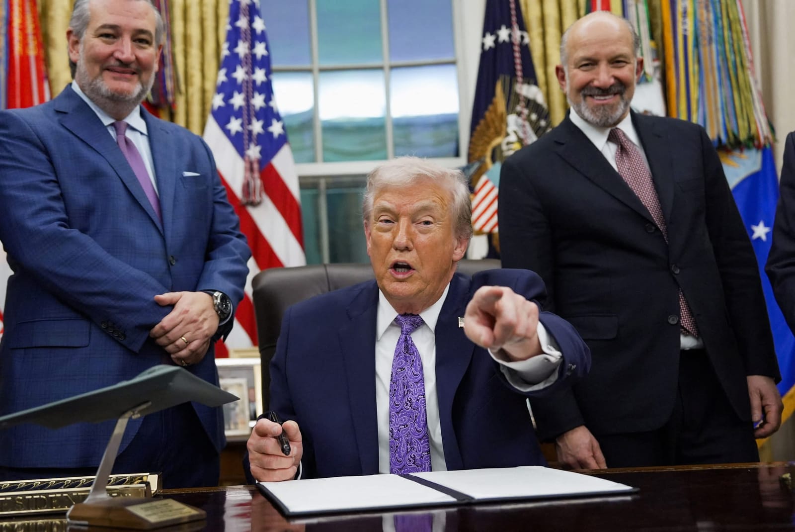 Donald Trump signe un décret dans le Bureau ovale, entouré de responsables